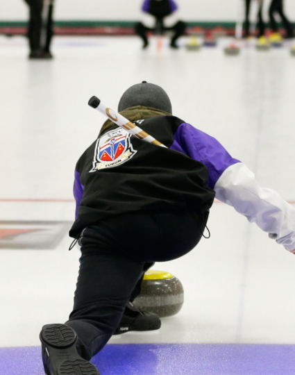 A Team Yukon curler leaves the hack